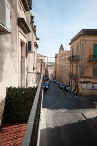 a city street with cars parked on the side of a building at Suite Barocca in Noto