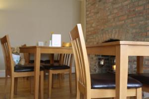 a dining room with a table and chairs and a brick wall at Nama-Stay Harrogate in Harrogate