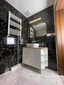 a bathroom with a sink and a mirror at Hotel ULYSSES in Mtskheta