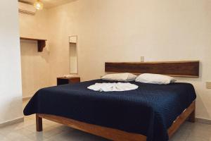 Postel nebo postele na pokoji v ubytování Hotel Xa´an Bacalar