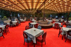 a restaurant with tables and chairs on a red carpet at Kumanovo Spa in Kumanovo