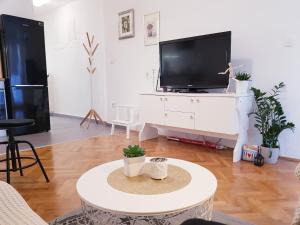 a living room with a tv and a table at Apartman Noa in Split