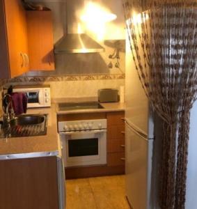 kuchnia z lodówką i kuchenką górny piekarnik w obiekcie Apartamento con 2 stanze letto w mieście Torrevieja