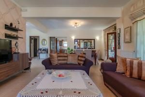 a living room with a couch and a table at Iris Villa in Prinés