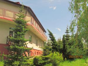 a building with trees in front of it at Fregata in Wilkasy