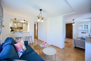 a living room with a blue couch and a table at Villa Baywatch in Galata