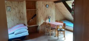 a bedroom with a table and a bed in a room at Wczasy u Jasia in Trzęsacz