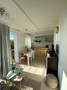 a living room with a table and a kitchen at Apartmani Anka Hvar in Hvar