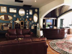 a living room with a couch and some mirrors at Hotel Hacienda Santana in Tecate +41 photos