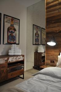 a bedroom with a bottle of whiskey on the wall at The Country Club in Toruń