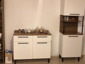 a kitchen with white cabinets and a counter at Concept House Caraiva in Caraíva