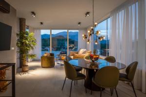 a living room with a glass table and chairs at Villa Buddha Bay in Korčula