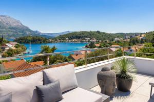 a balcony with a couch and a view of a river at Villa Buddha Bay in Korčula