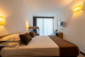 Postel nebo postele na pokoji v ubytování Hotel Cristallo