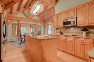 a large kitchen with wooden cabinets and a chandelier at Freedom's Private Retreat in Freedom