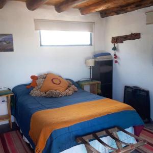 a bedroom with a bed with a teddy bear on it at La Casa de Vero in Cachí