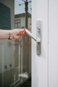a persons hand holding a door handle at Tiny Beach House Zandvoort in Zandvoort