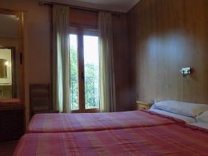 Postel nebo postele na pokoji v ubytování Hostal Los Palancares