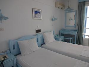 Postel nebo postele na pokoji v ubytování Remezzo Hotel & Studios