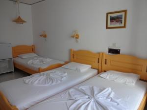 Postel nebo postele na pokoji v ubytování Remezzo Hotel & Studios