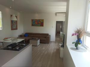 a kitchen and living room with a stove and a couch at NoAr Apartment Rijeka in Rijeka