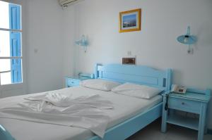 Postel nebo postele na pokoji v ubytování Remezzo Hotel & Studios