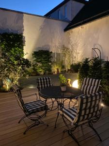 a patio with a table and chairs on a deck at Altstadt-Chalet @Conny's in Brilon