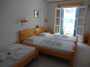 Postel nebo postele na pokoji v ubytování Remezzo Hotel & Studios