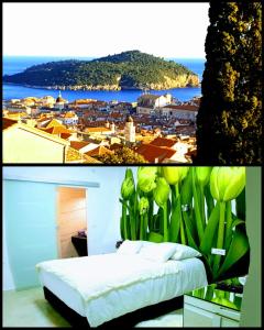 a bedroom with a bed and a view of a city at Apartments Lomara in Dubrovnik