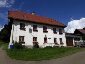 a large white building with a red roof at Graslandhof in Neumarkt in Steiermark