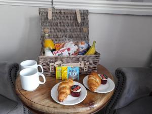a wooden table topped with a basket filled with food at Fairwater Head in Axminster