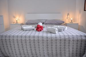 a teddy bear sitting on a bed with pillows at Casa Vacanze Falco in Agropoli