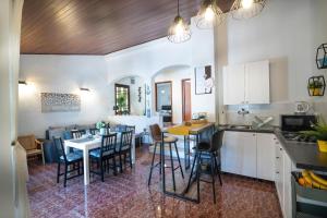 a kitchen and dining room with a table and chairs at Holiday house KIM in Kali