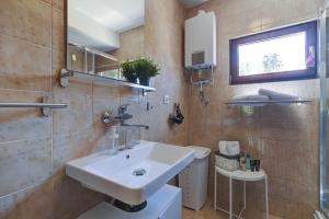a bathroom with a sink and a toilet at Holiday house KIM in Kali +44 photos