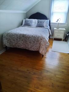 a bedroom with a bed and a wooden floor at Willow B Inn in Kingsville