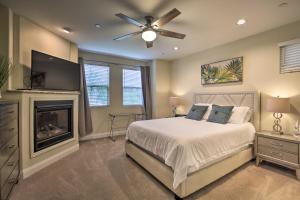 a bedroom with a bed with a ceiling fan and a fireplace at Sunny SoCal Hideaway Less Than 2 Miles to Pacific Beach! in San Diego