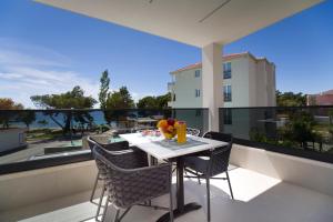 a table and chairs on a balcony with a view at Villa IN in Promajna