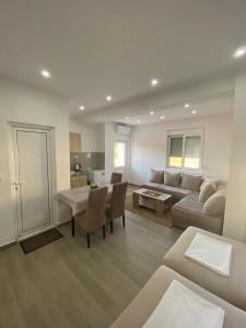 a living room with a couch and a table at Gjoni Apartments in Ulcinj