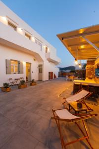 an outdoor patio with chairs and tables in a building at The Be House in Sifnos