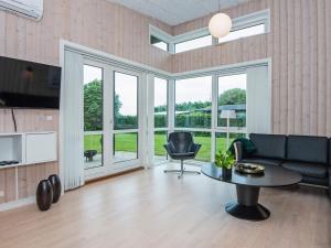 a living room with a couch and a table at 6 person holiday home in Haderslev in Årøsund