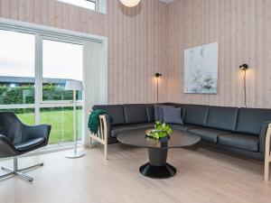 a living room with a couch and a table at 6 person holiday home in Haderslev in Årøsund