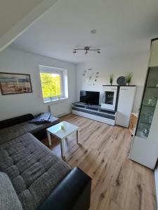 a living room with a couch and a table at Ferienhaus Taucherperle in Hemmoor