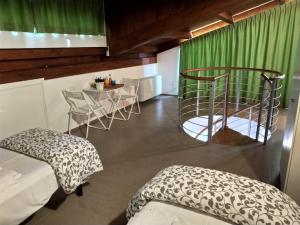 a room with green curtains and a table and chairs at Big Sabaudia in Sabaudia