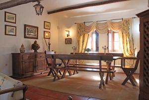a dining room with a table and a bench at Monte Pinheiro in Rabaços +23 photos