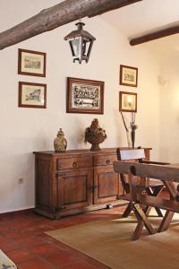 a dining room with a wooden cabinet and a table at Monte Pinheiro in Rabaços