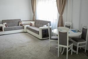 a living room with a couch and a table at Vila Kalliopi in Eforie Nord