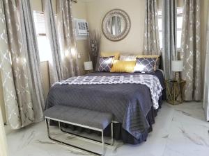 a bedroom with a bed and a mirror and curtains at Glam Private Studio 4 Miles from Beach in Hollywood