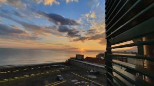 a view of the ocean at sunset from a building at Fenestammare in Castellammare di Stabia