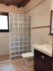 a bathroom with a toilet and a sink at AldeaMia, Cozy villa for 8 people, pool, mountain view, beach at 8 min in Vilanova de Escornalbou