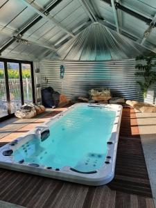 a large hot tub in a room with at River Rock Estate in Cromwell